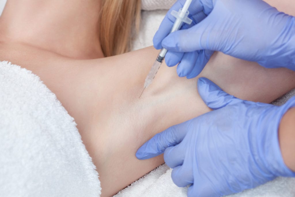 The doctor makes intramuscular injections of botulinum toxin in